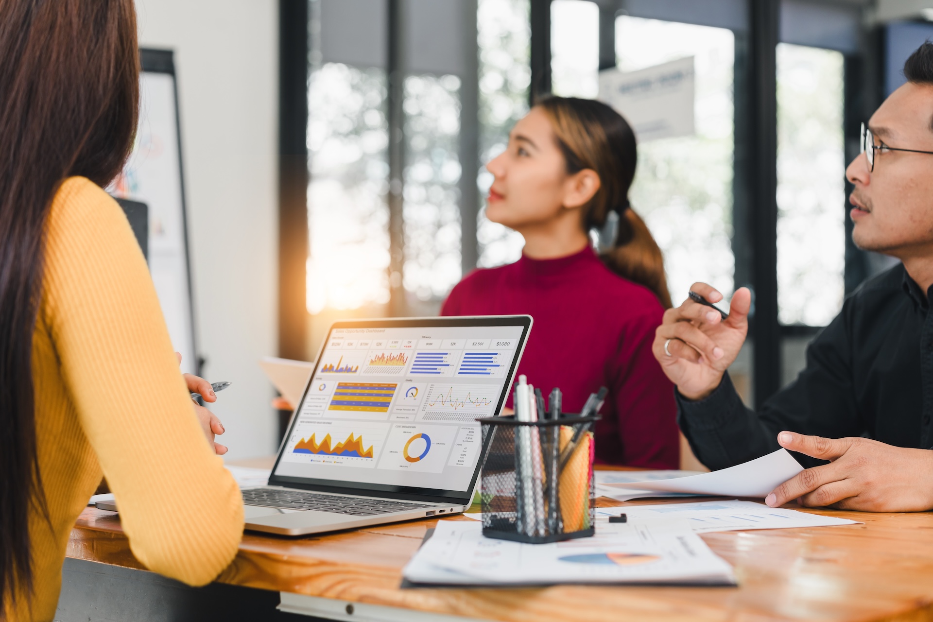 A Team discussing data analytics with laptop on table